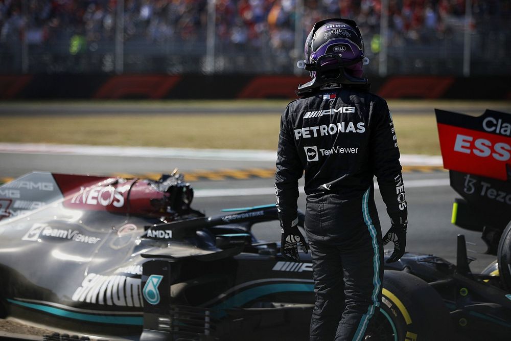 Lewis Hamilton, Mercedes, walks away after crashing out of the race with Max Verstappen, Red Bull Racing