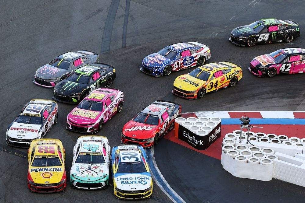 Field races three and four wide through Turn 7 hairpin