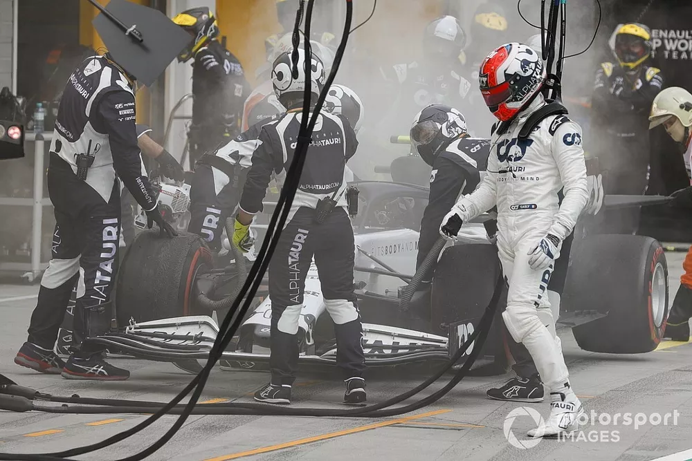 Pierre Gasly, AlphaTauri, climbs out of his car after it erupts in smoke