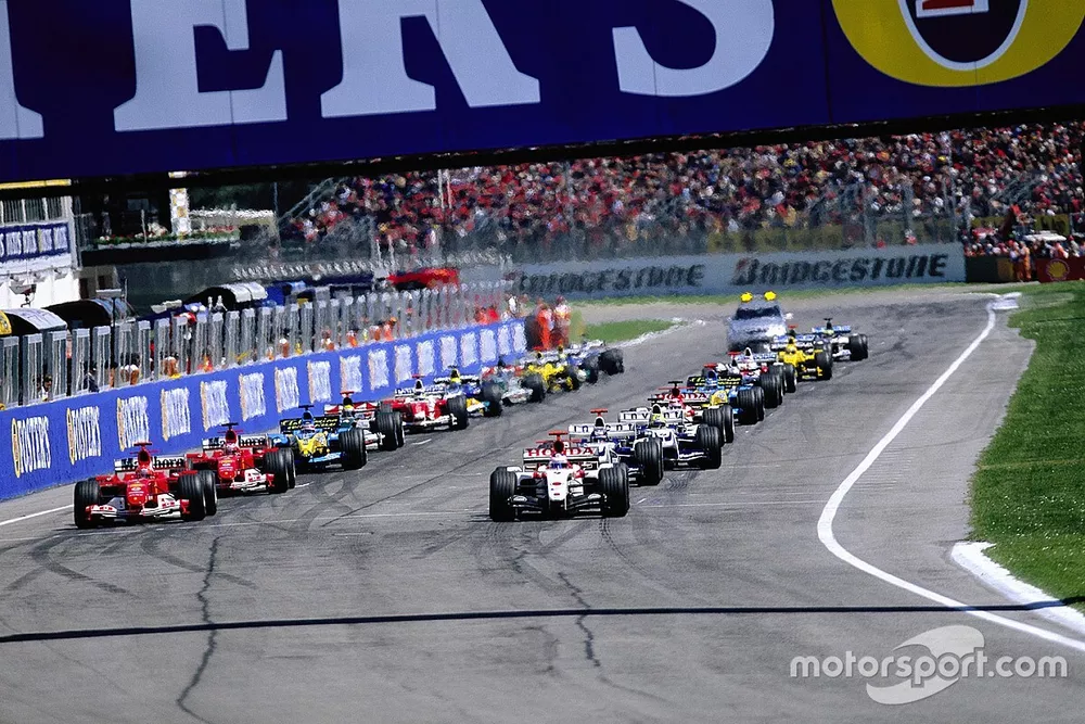 Jenson Button, BAR 006 Honda, pulls away from Michael Schumacher, Ferrari F2004, off the line at the start 