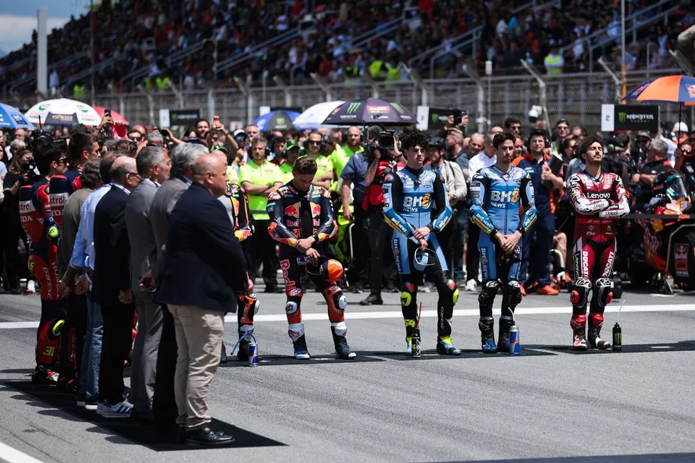 MotoGP riders stand for the playing of the National Anthems 