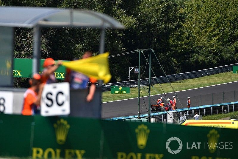 Yellow flag is waved with race retiree Daniel Ricciardo, Red Bull Racing RB13 in the background