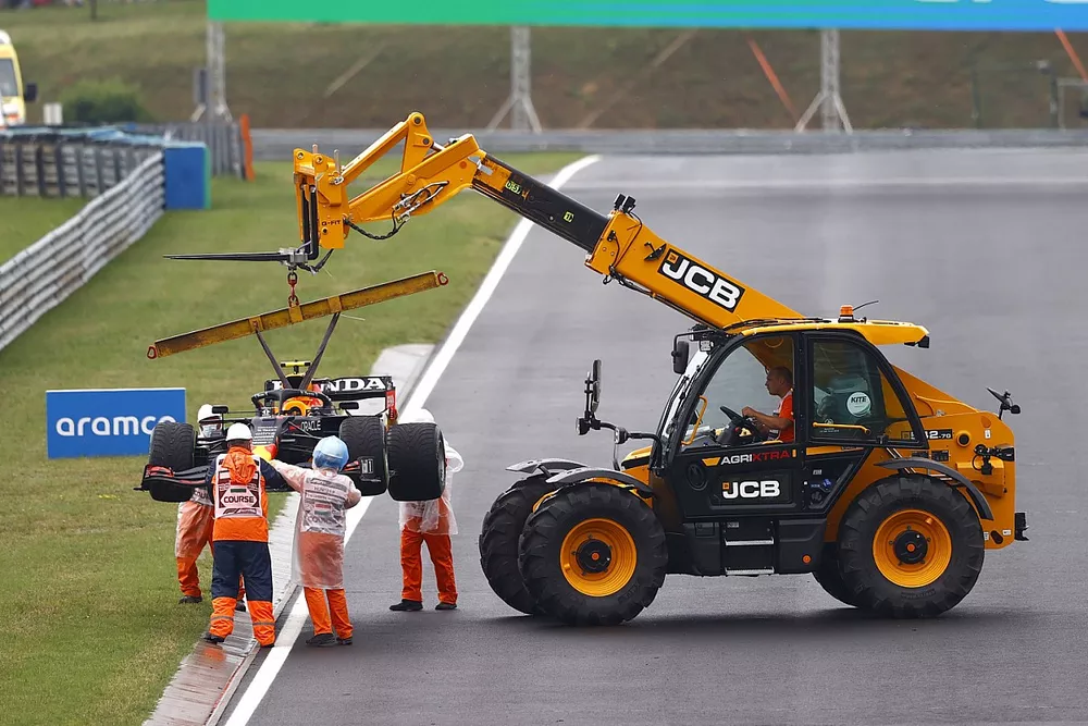 Marshals remove the damaged car of Sergio Perez, Red Bull Racing RB16B