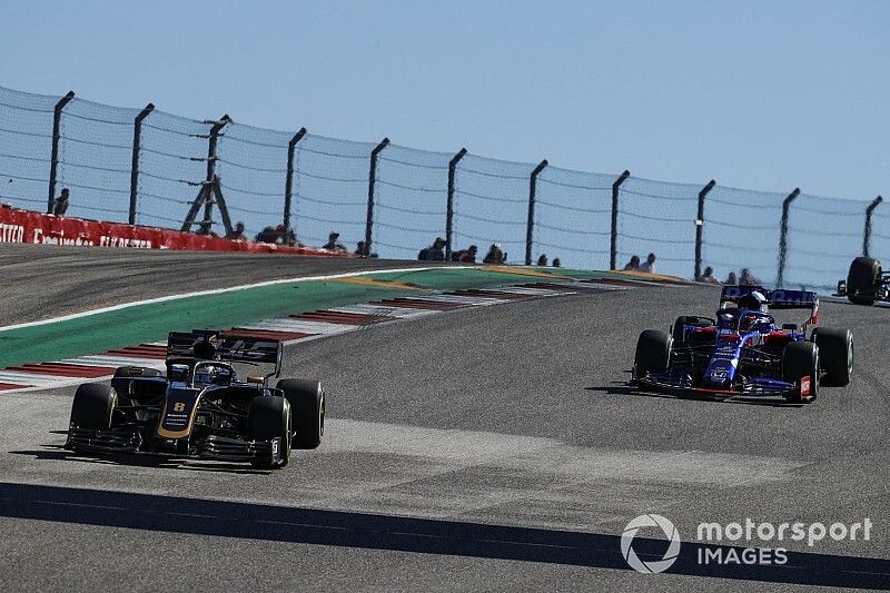 Romain Grosjean, Haas F1 Team VF-19, leads Pierre Gasly, Toro Rosso STR14