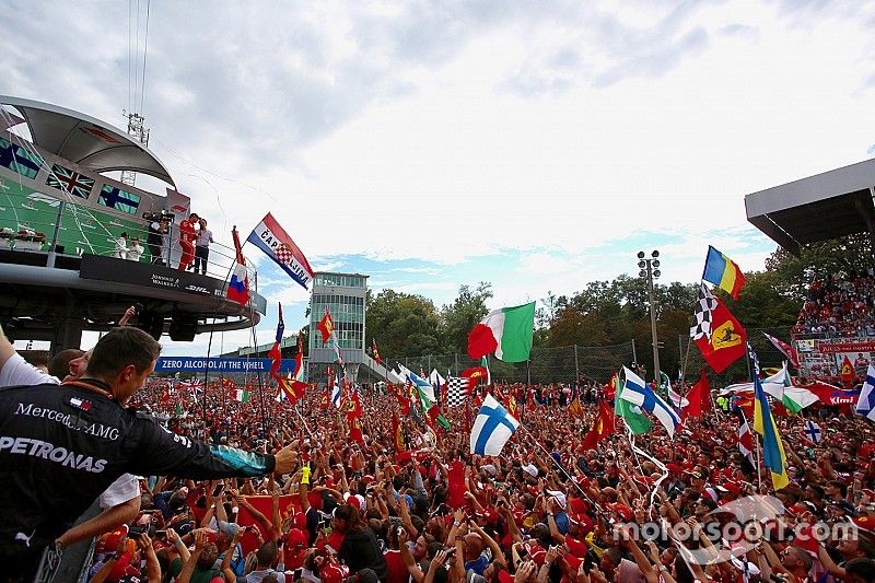 Fans invade the track to watch the podium