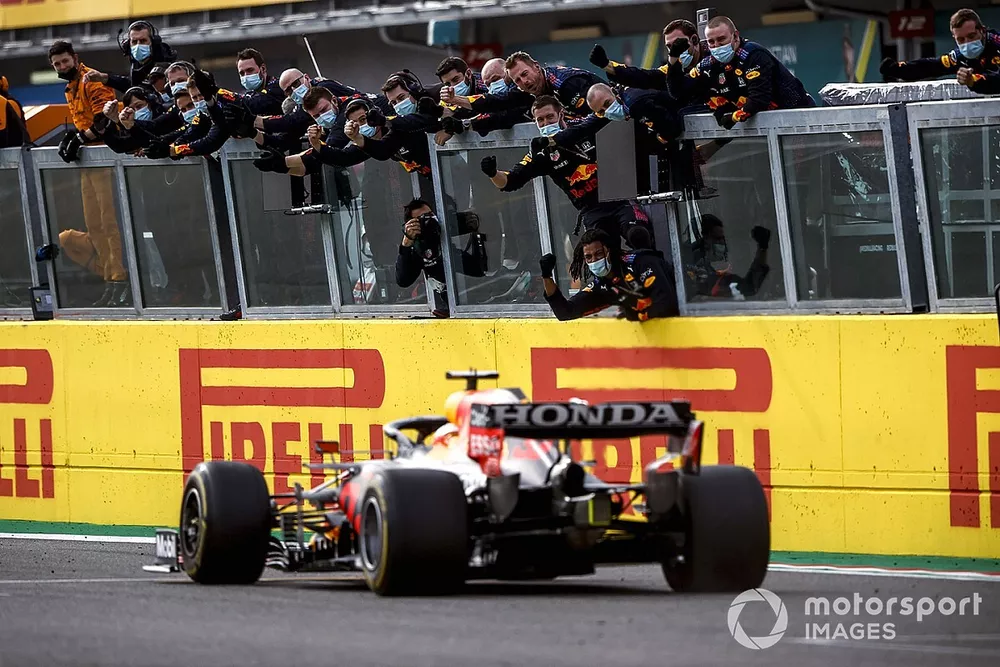 Race winner Max Verstappen, Red Bull Racing RB16B crosses the finish line to his team celebrating