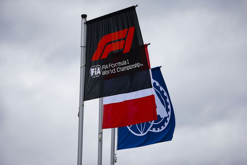 The Austrian flag flies alongside others displaying the Formula 1 and FIA logos