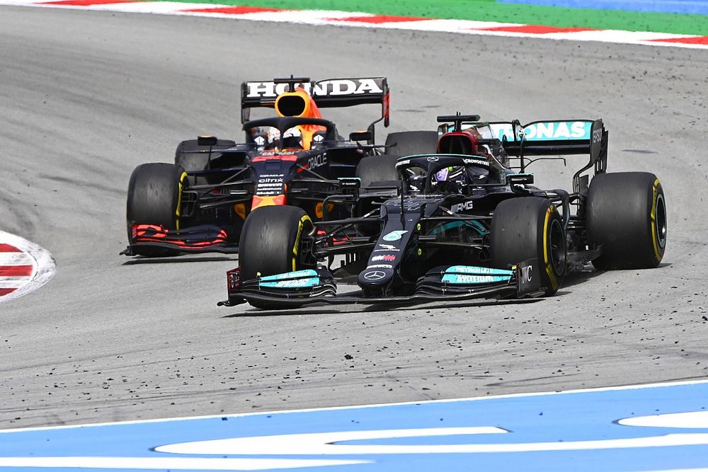 Lewis Hamilton, Mercedes W12, passes Max Verstappen, Red Bull Racing RB16B, for the lead