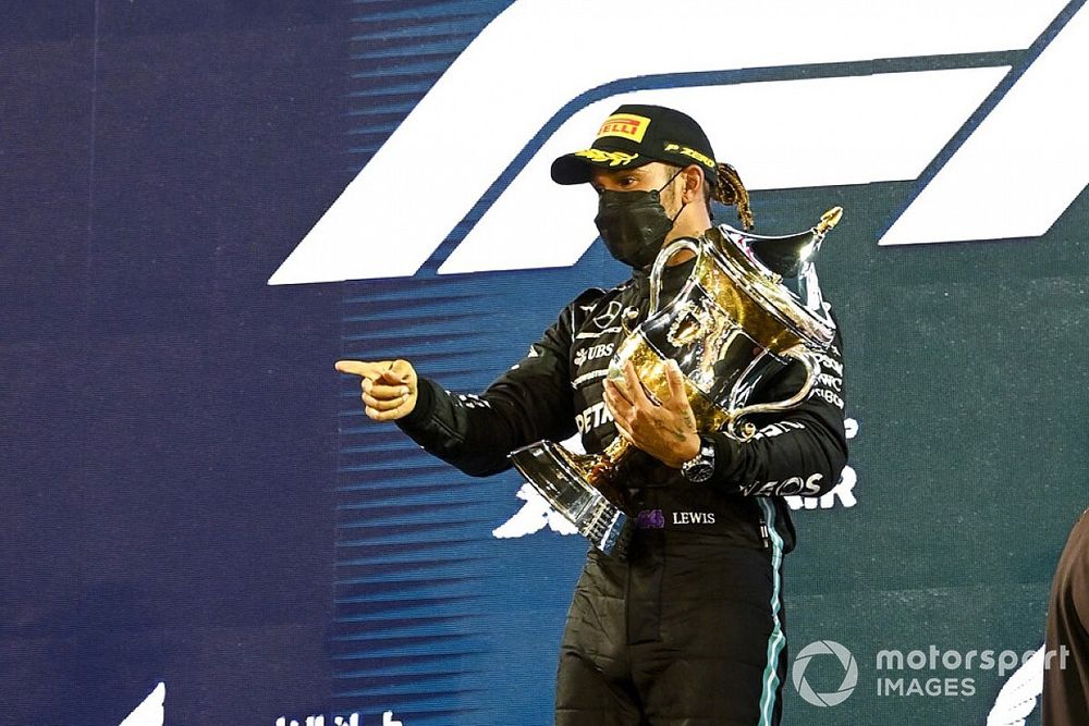 Race Winner Lewis Hamilton, Mercedes celebrates on the podium with the trophy