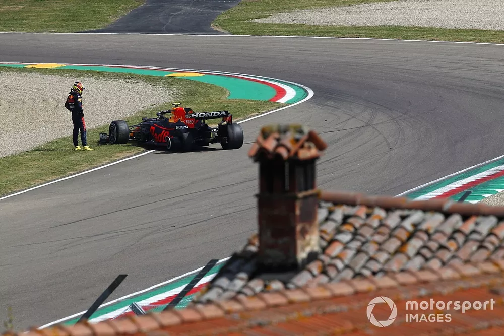 Sergio Perez, Red Bull Racing RB16B, looks at his car after stopping on track