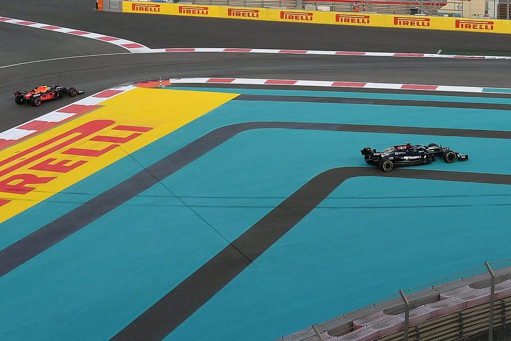 Lewis Hamilton, Mercedes W12, runs across the inside as Max Verstappen, Red Bull Racing RB16B