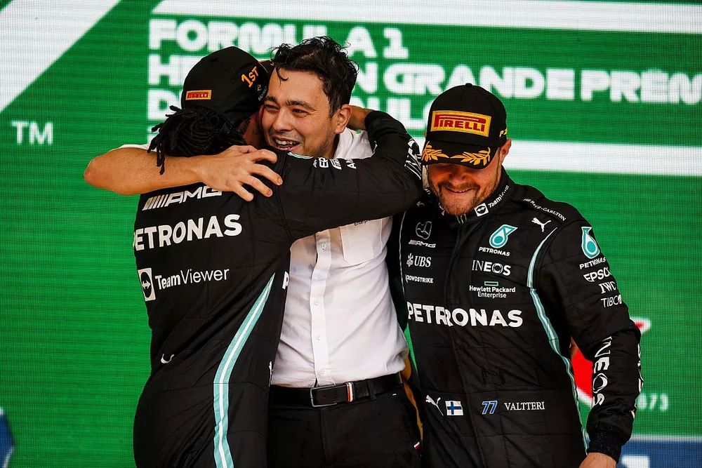 Lewis Hamilton, Mercedes, 1st position, and Valtteri Bottas, Mercedes, 3rd position, celebrate with their team mate on the podium