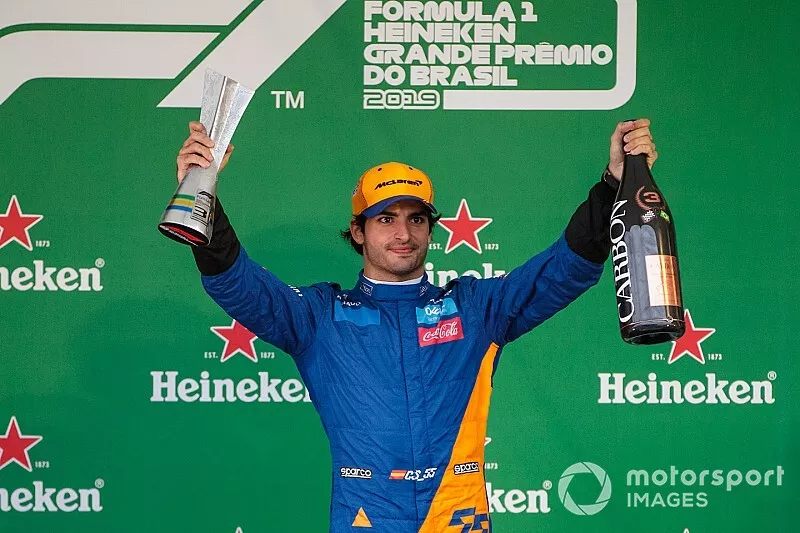 Carlos Sainz Jr, McLaren celebrates his third position on the podium with the trophy