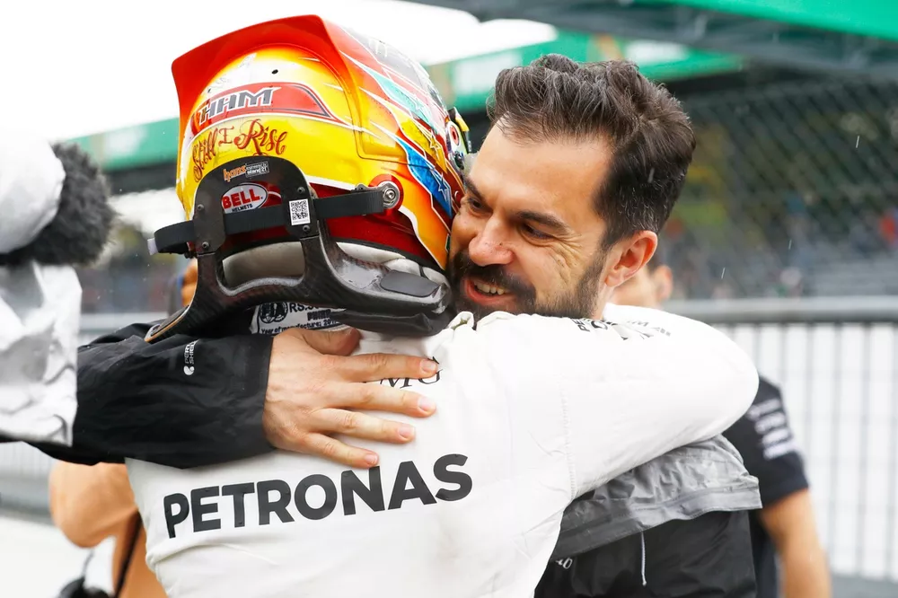 Lewis Hamilton, Mercedes AMG, celebrates with Marc Hynes after taking his 69th F1 Pole Position