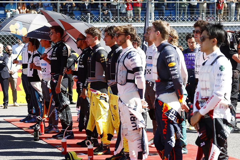 Los pilotos se colocan en la parrilla para escuchar el himno nacional antes de la salida