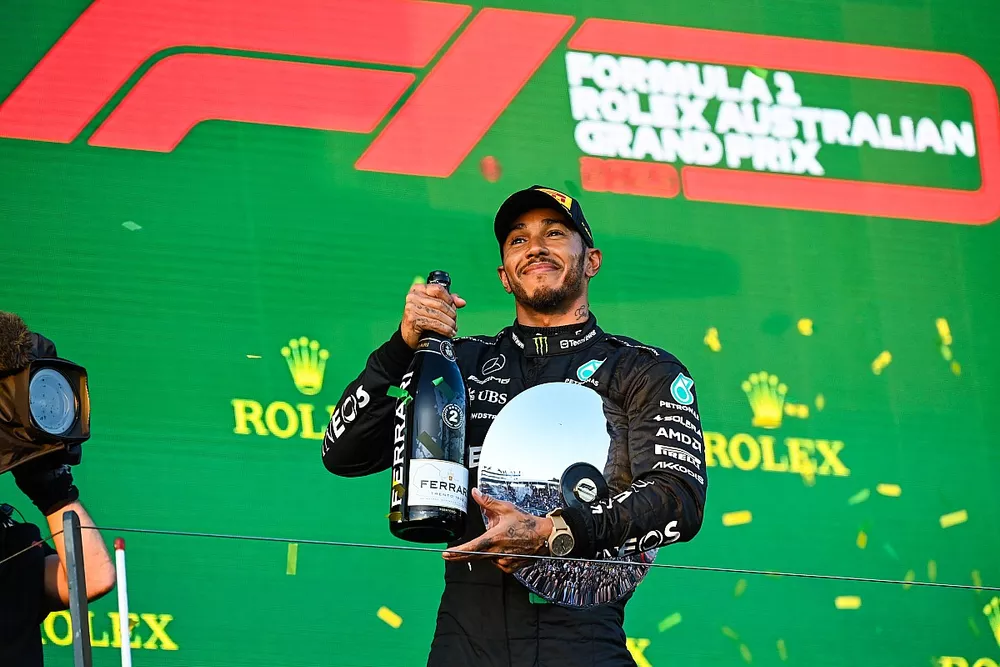 Lewis Hamilton, Mercedes-AMG, 2nd position, with his trophy and Champagne on the podium