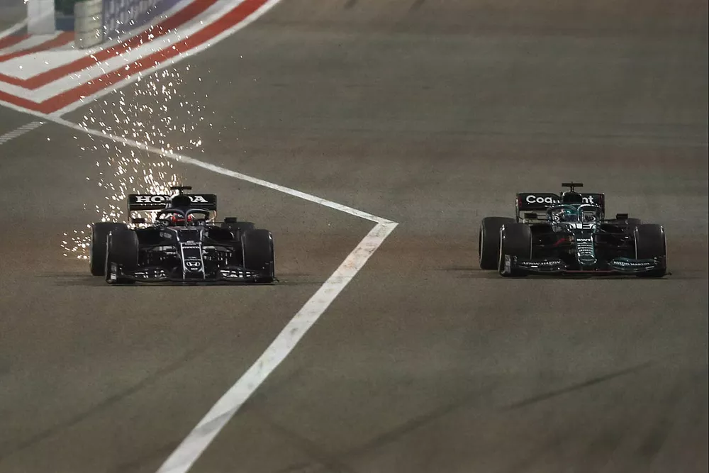Sparks fly as Yuki Tsunoda, AlphaTauri AT02, battles with Lance Stroll, Aston Martin AMR21