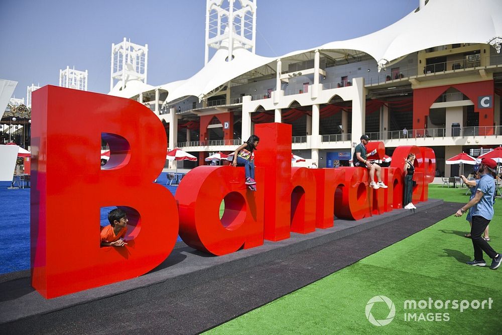 Children play on a giant Bahrain sign