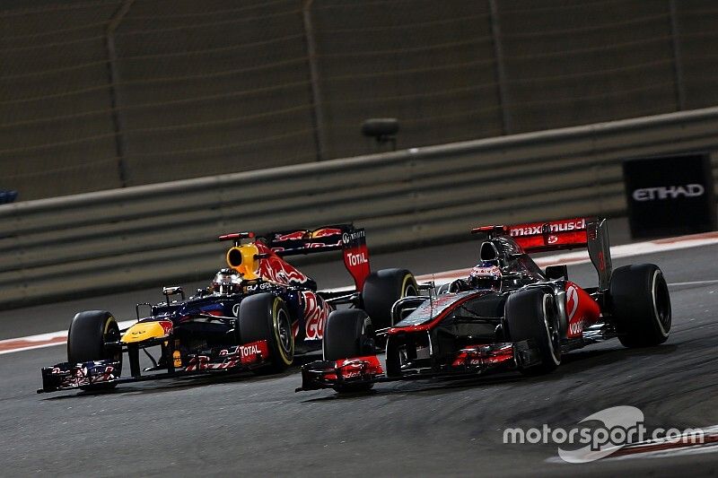 Jenson Button, McLaren MP4-27, leads Sebastian Vettel, Red Bull RB8