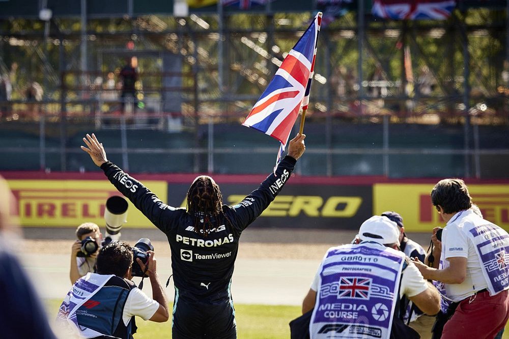 Lewis Hamilton, Mercedes , 1st position, celebrates with a Union flag after the race