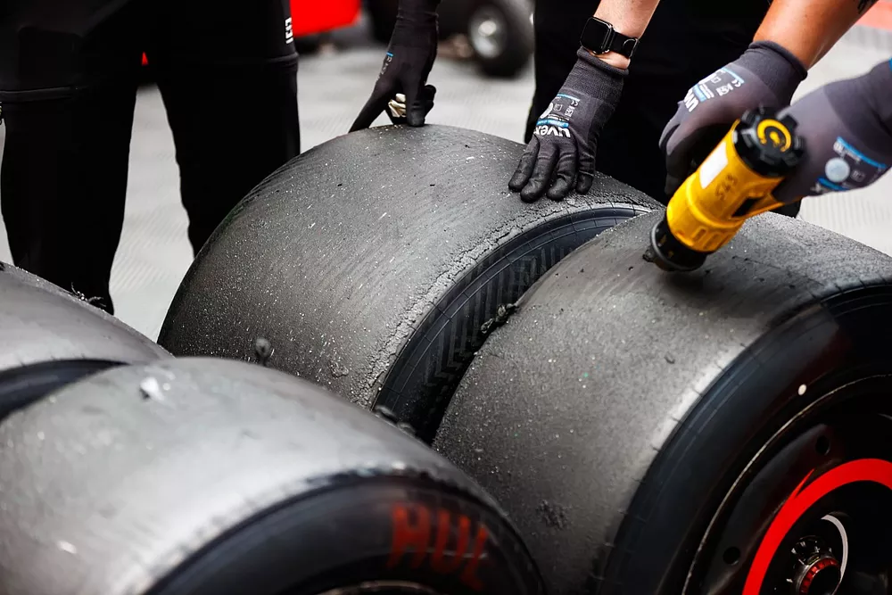 A Pirelli technician works on some tyres