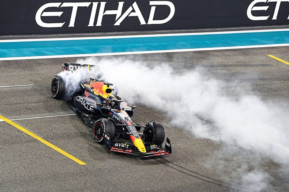 World Champion Max Verstappen, Red Bull Racing RB18, 1st position, performs donuts on the grid in celebration