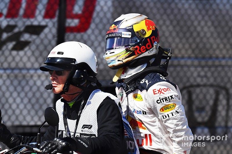 Daniel Ricciardo, Red Bull Racing on the back of a motorbike after retiring 