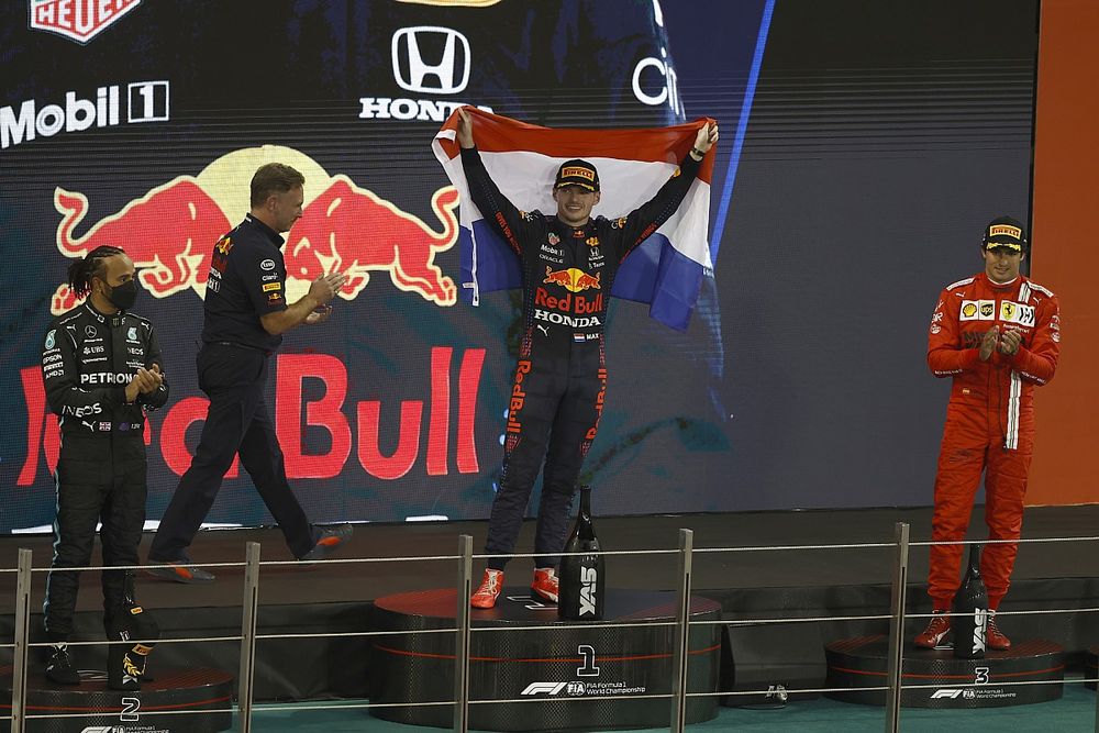 Max Verstappen, Red Bull Racing, 1st position, celebrates on the podium with a Dutch flag between Lewis Hamilton, Mercedes, 2nd position, Carlos Sainz Jr., Ferrari, 3rd position