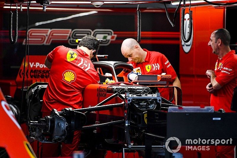 Ferrari mechanics prepare the car of Sebastian Vettel, Ferrari SF90, for wet weather, in the garage