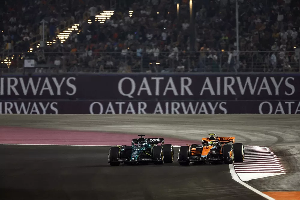 Lance Stroll, Aston Martin AMR23, battles with Lando Norris, McLaren MCL60