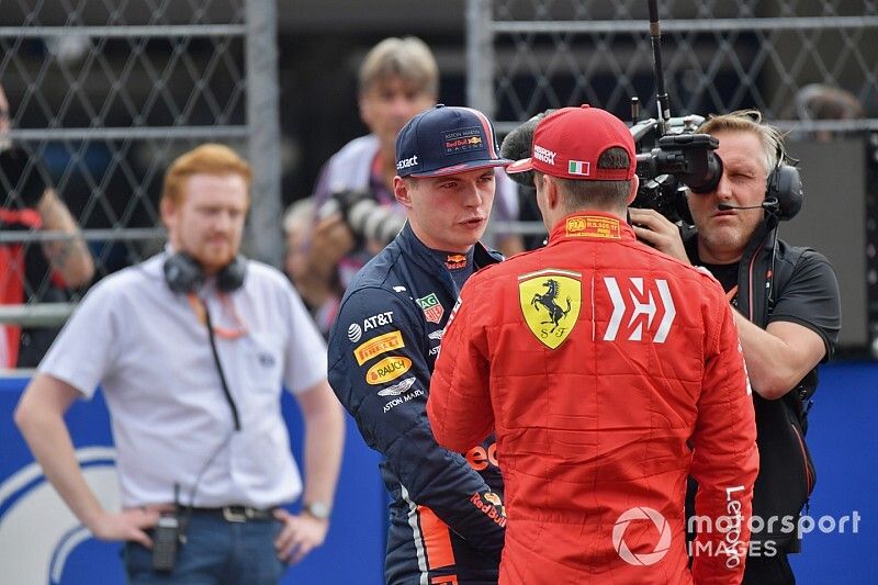 Charles Leclerc, Ferrari, congratulates Max Verstappen, Red Bull Racing, on pole