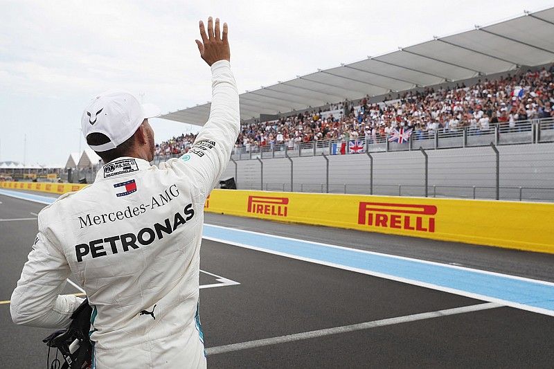 Lewis Hamilton, Mercedes AMG F1, waves to the fans after taking pole position