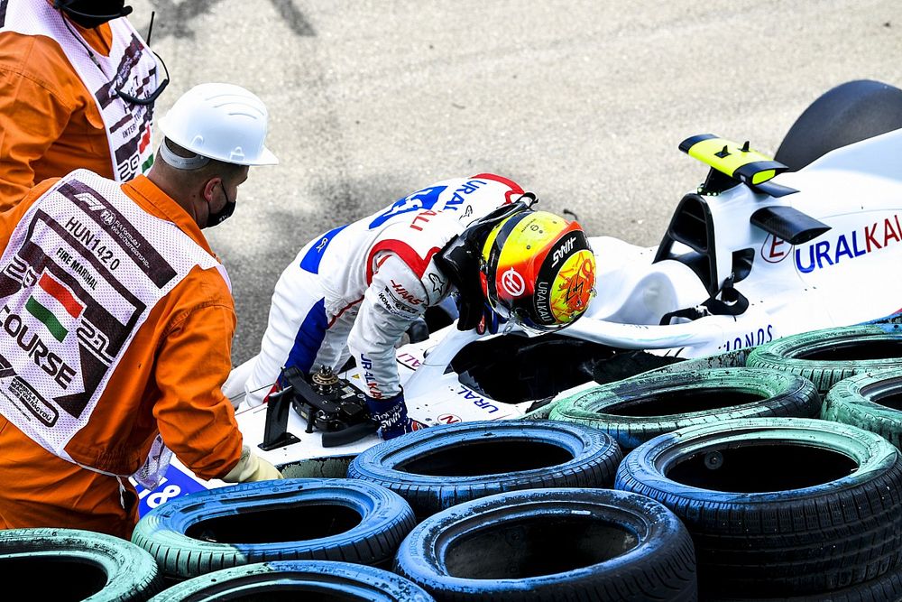 Marshals assist Mick Schumacher, Haas F1, after his crash in FP3