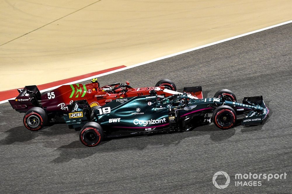 Lance Stroll, Aston Martin AMR21, passes Carlos Sainz Jr., Ferrari SF21