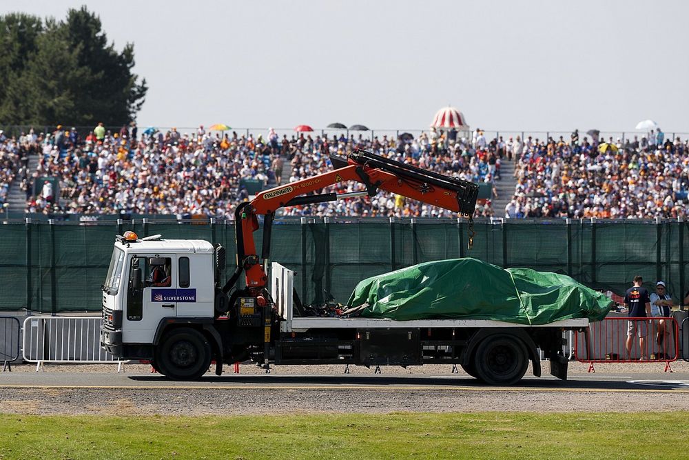 The car of Max Verstappen, Red Bull Racing RB16B, is returned to the garage on  a truck under a tarpaulin