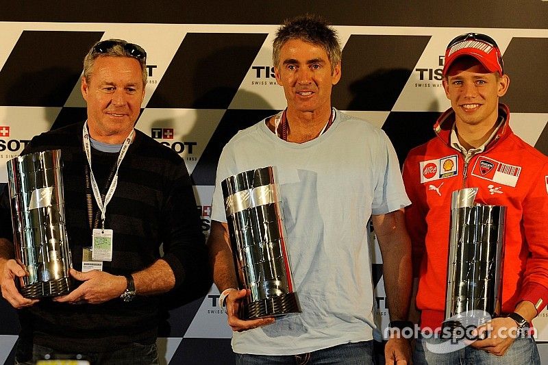 Casey Stoner reçoit une réplique du trophée première-classe en reconnaissance du championnat du monde de 2007 et pose avec Mick Doohan et Wayne Gardner