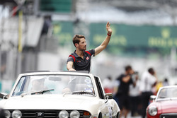 Romain Grosjean, Haas F1 Team, waves from a Triumph Stag on the drivers parade