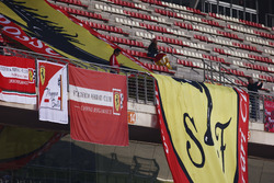 Ferrari flags on display in the pit straight grandstand