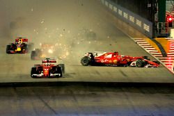 Sebastian Vettel, Ferrari SF70H leads at the start of the race and the cars of Kimi Raikkonen, Ferrari SF70H and Max Verstappen, Red Bull Racing RB13 crash after colliding