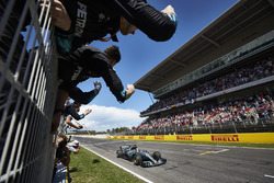 Lewis Hamilton, Mercedes AMG F1 W08, race winner, crosses the line to the delight of his team