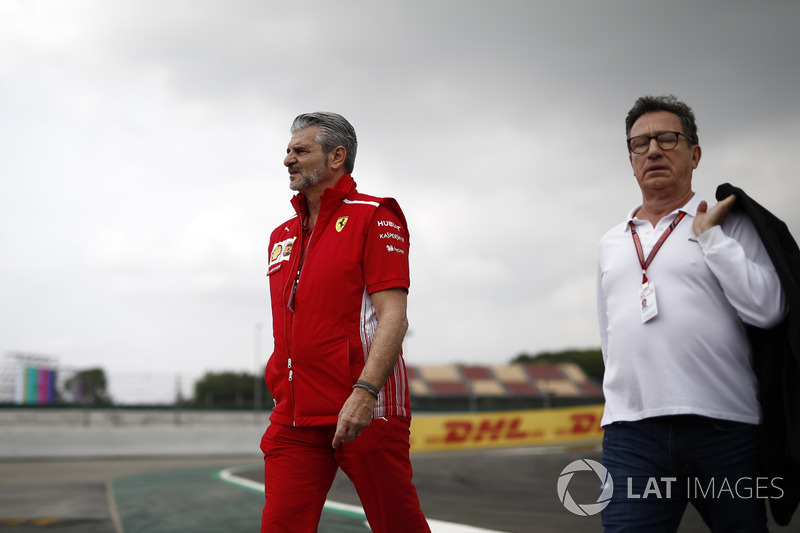 Maurizio Arrivabene, Ferrari Team Principal and Louis Camilleri, Chairman of Philip Morris walk the track