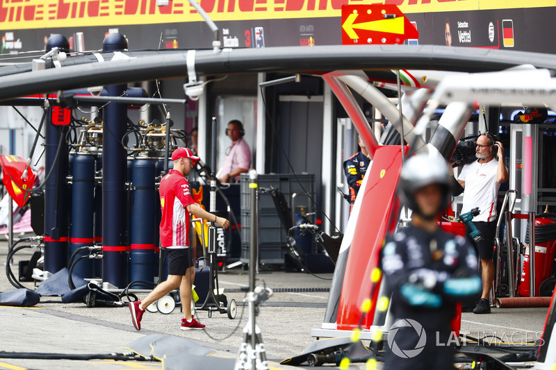 Sebastian Vettel, Ferrari, walks into the garage after crashing out