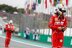 Sebastian Vettel, Ferrari, Kimi Raikkonen, Ferrari, walk back into the pits after qualifying