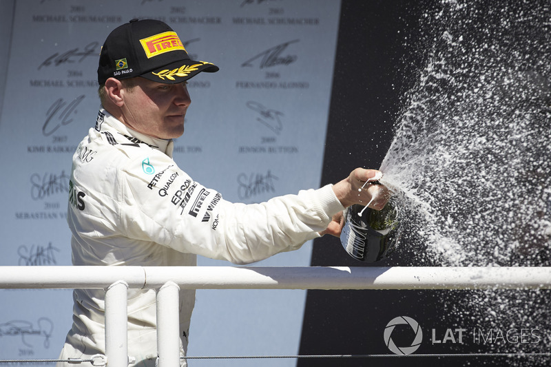 Second place Valtteri Bottas, Mercedes AMG F1, sprays Champagne on the podium