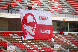 Fans tie down a flag in support of Robert Kubica, Williams FW41