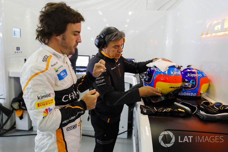 Fernando Alonso, McLaren, prepares to put on his helmet