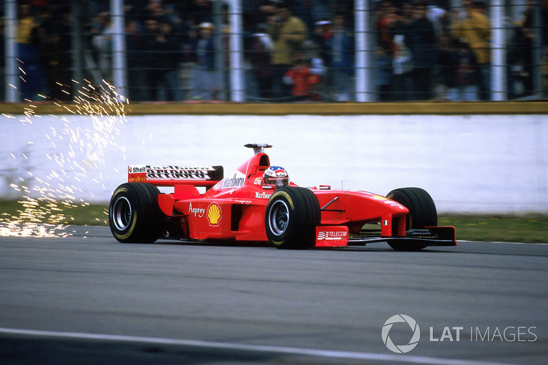 Michael Schumacher, Ferrari F300 kicks up sparks on the main straight