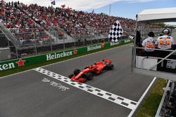 Kimi Raikkonen, Ferrari SF71H takes the chequered flag waved by Winnnie Harlow (CDN)