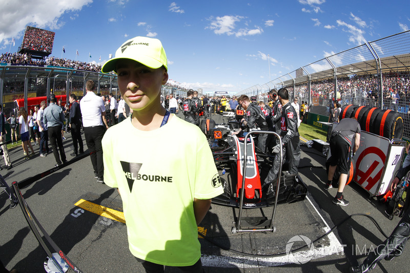 A Melbourne grid mascot stands in front of the car of Kevin Magnussen, Haas F1 Team VF-18 Ferrari