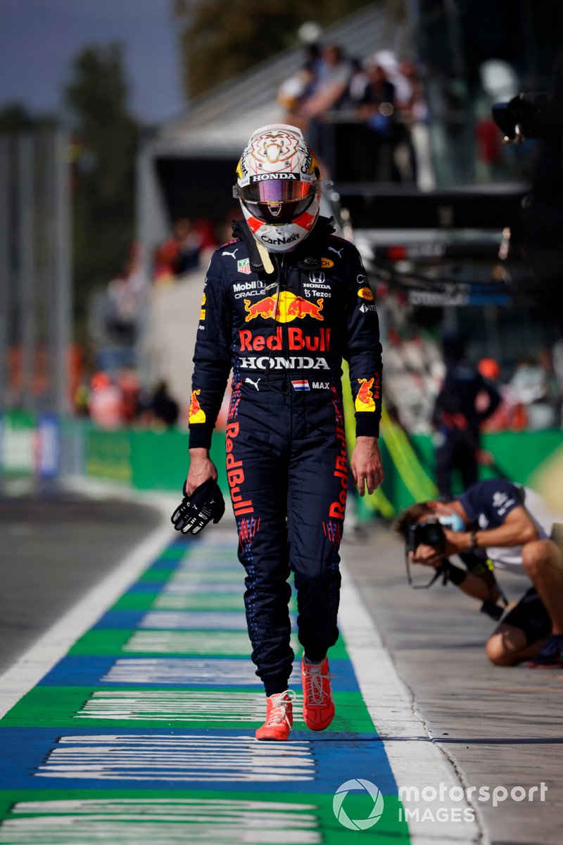 A dejected Max Verstappen, Red Bull Racing, walks back to the pits after crashing out with Lewis Hamilton, Mercedes